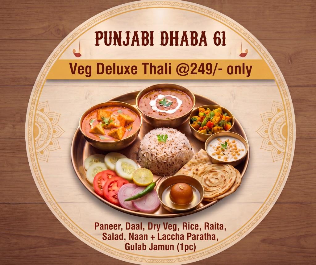 Veg deluxe thali on a copper plate with curries, rice, breads, salad and gulab jamun